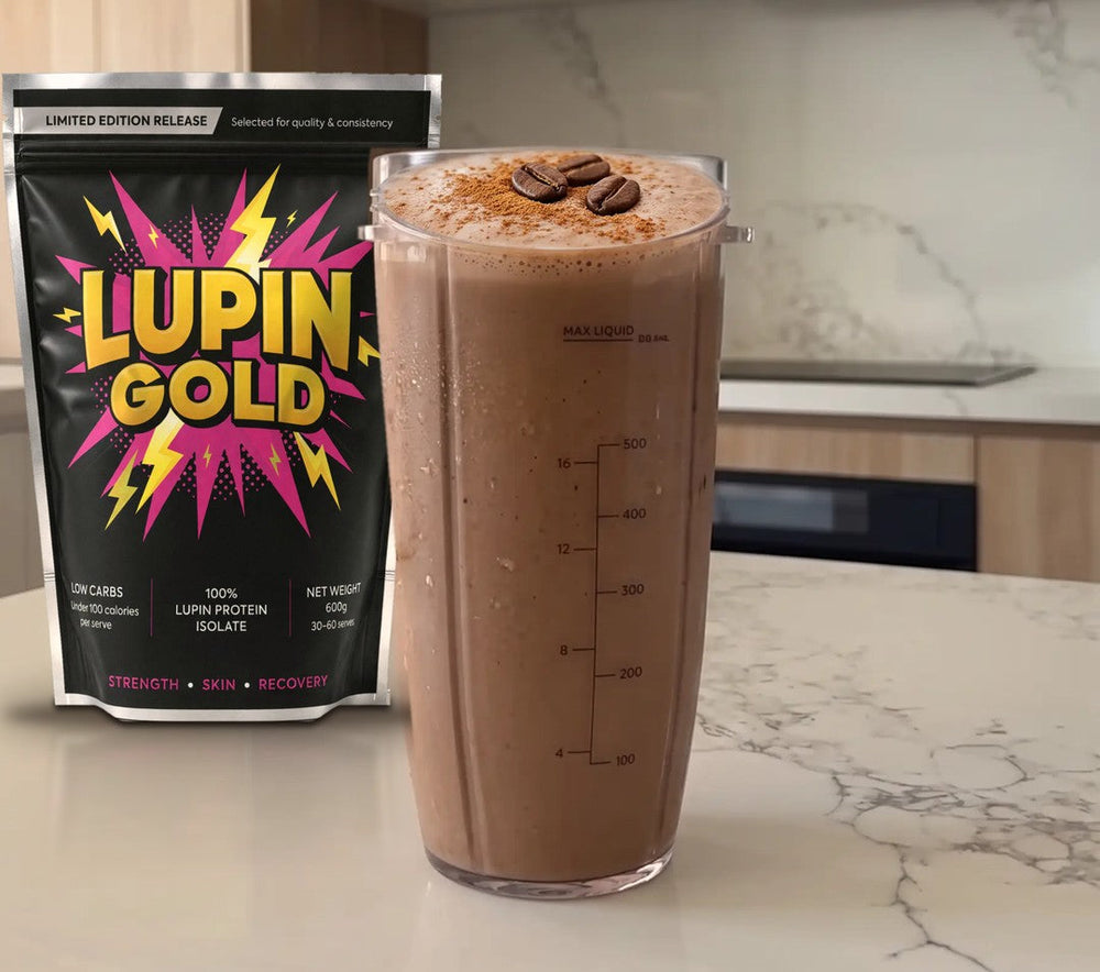 Iced mocha protein coffee in a blender cup beside a pack of Lupin Gold protein isolate