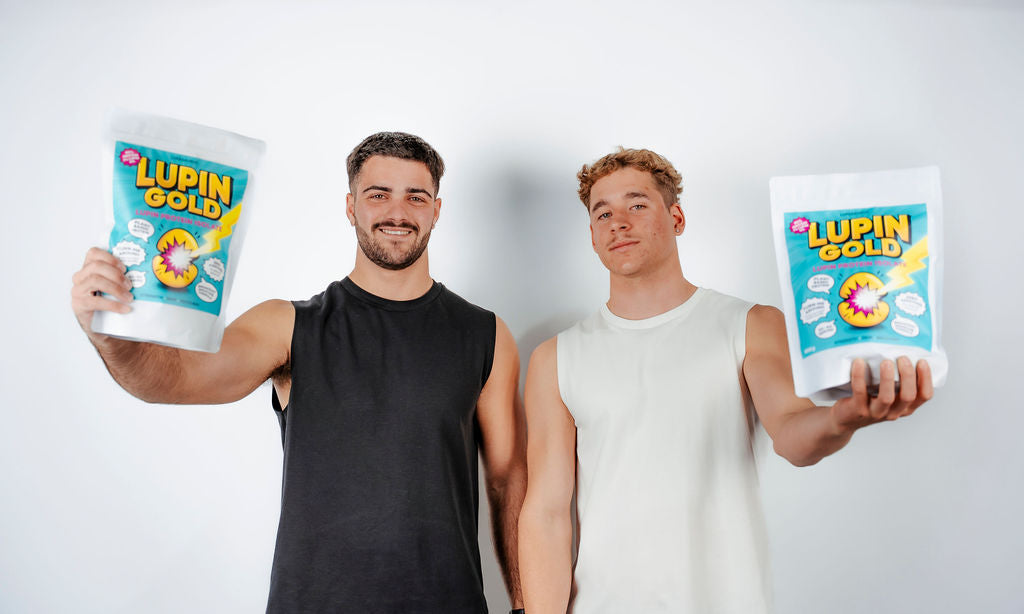 Two men holding packets of Lupin Gold Protein Isolate