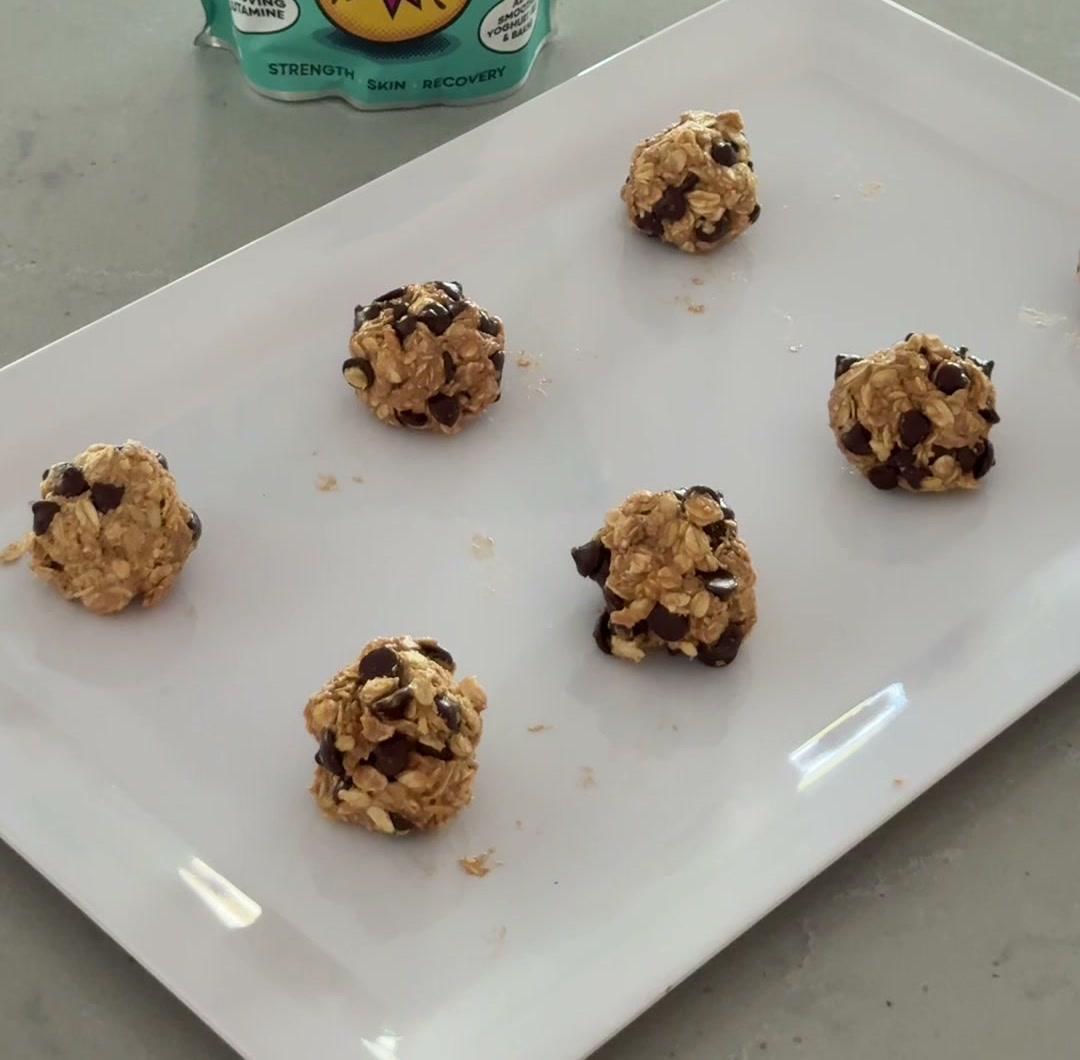 Choc chip peanut butter protein balls rolled and plated on a white serving dish