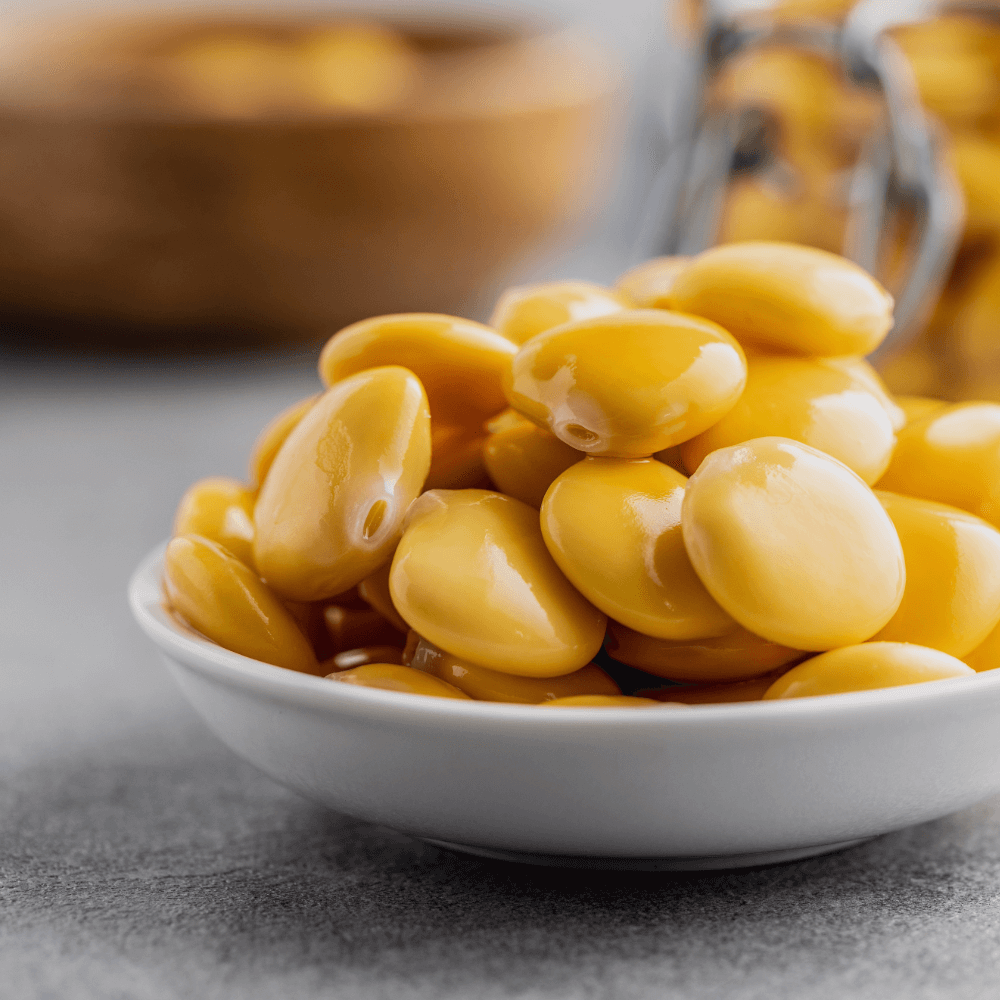 White bowl filled with Lupin beans on a gray surface